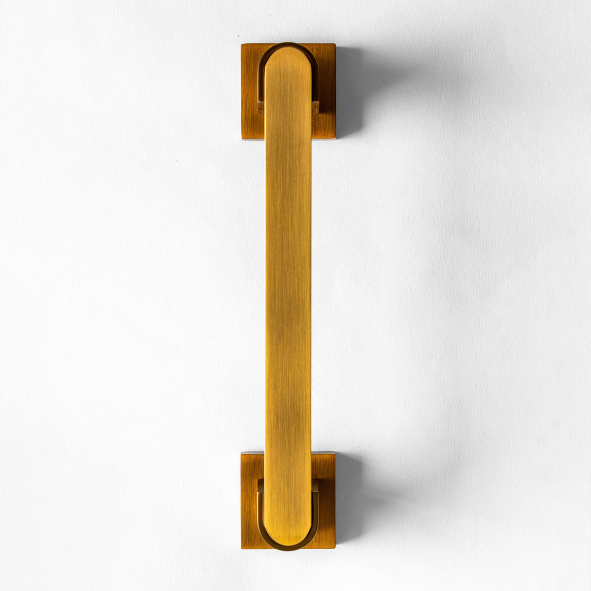 An Oxide metal door pull handle against a white background.