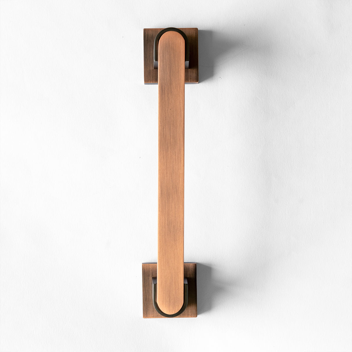 A Red Oxide metal door pull handle against a white background.