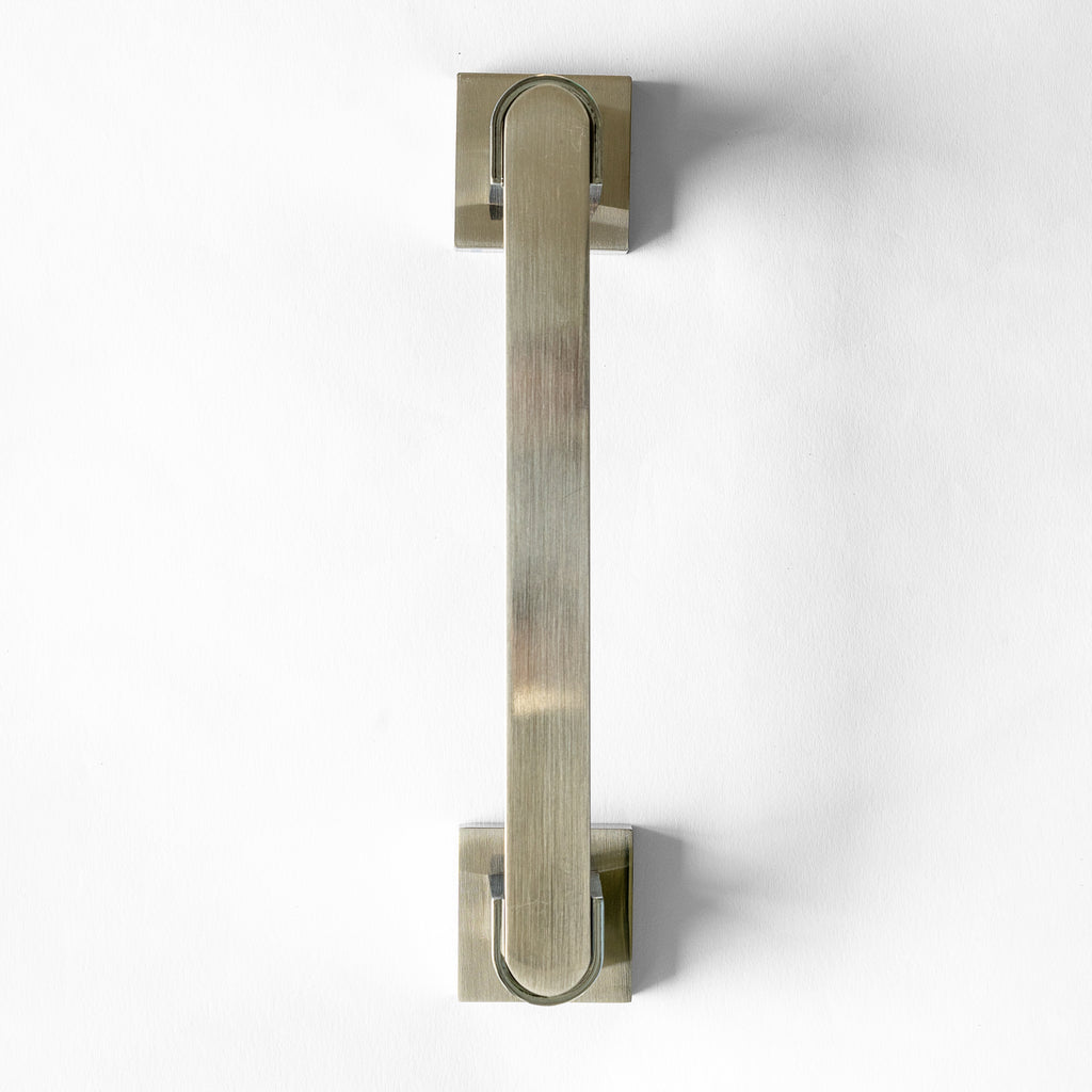 A silver metal door pull handle against a white background.