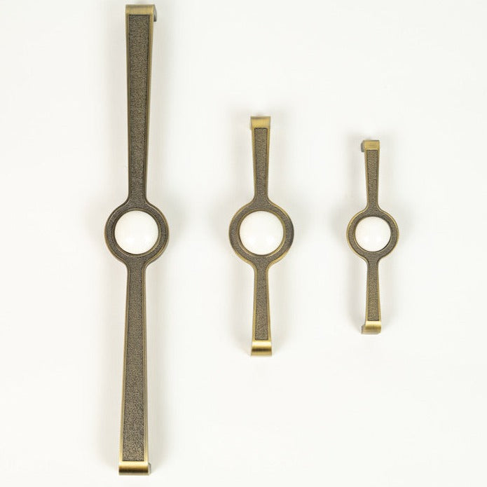 A set of three zinc alloy cabinet pulls in oxide white color, displayed in different sizes.