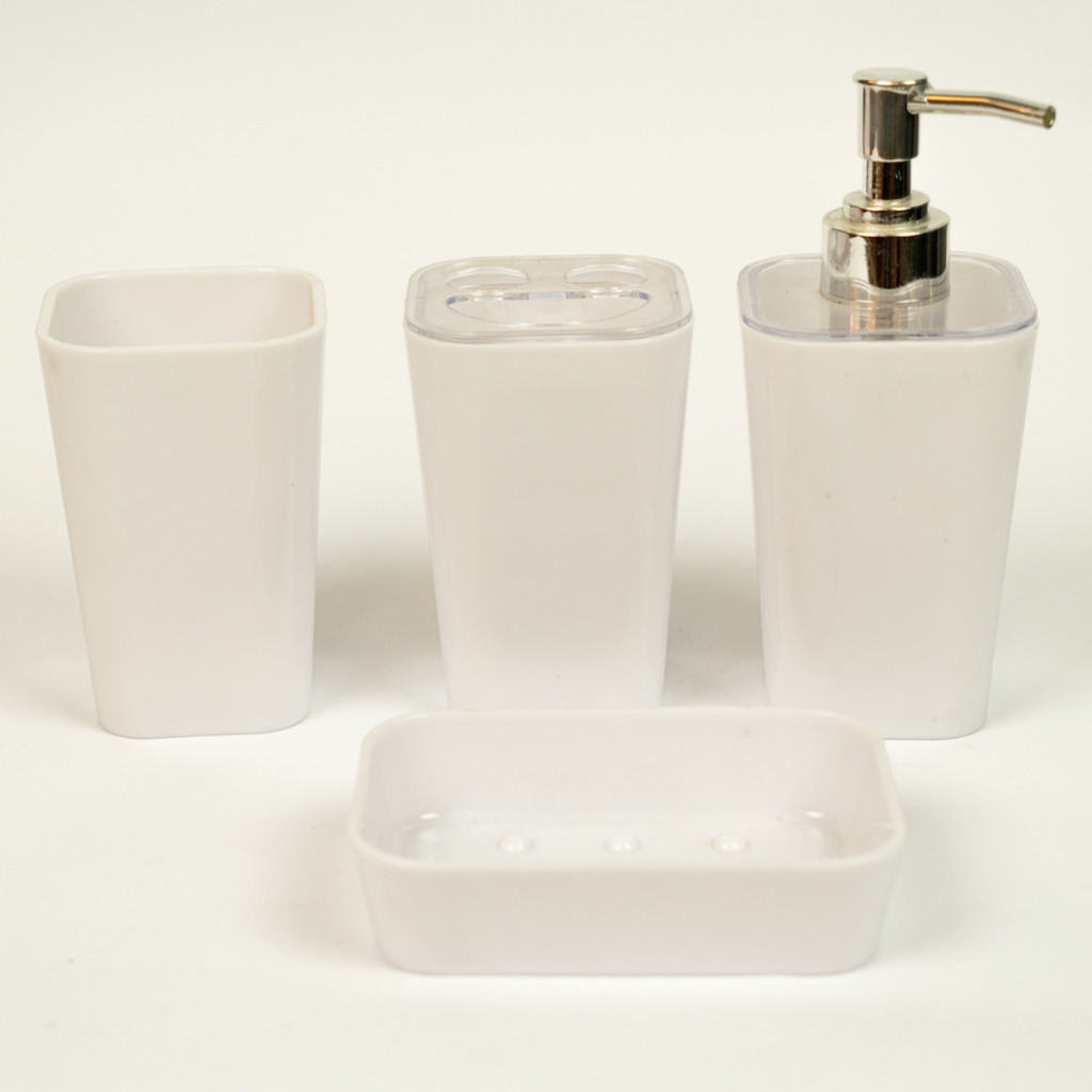 A set of white acrylic bathroom accessories, including a soap dispenser, toothbrush holder, tumbler, and soap dish.