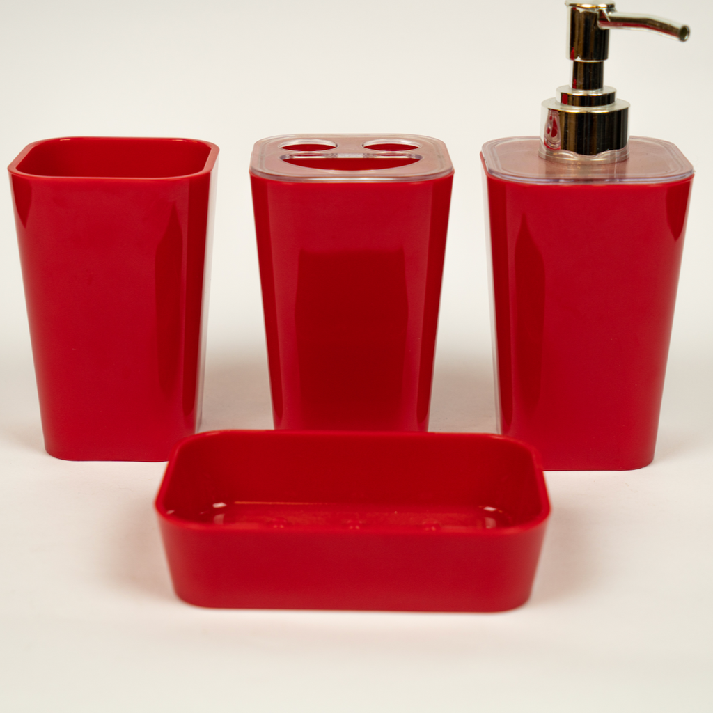 A set of red acrylic bathroom accessories, including a soap dispenser, toothbrush holder, tumbler, and soap dish.