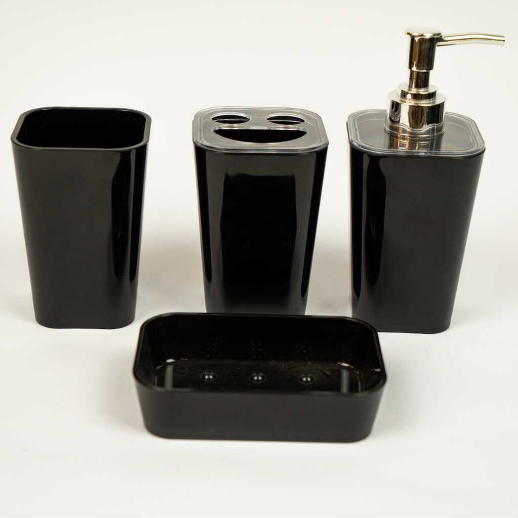 A set of black acrylic bathroom accessories, including a soap dispenser, toothbrush holder, tumbler, and soap dish.