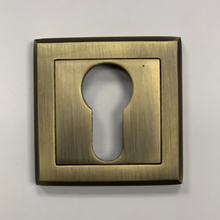 Load image into Gallery viewer, A square brass door cylinder cover with a keyhole in the center, displayed against a plain background.
