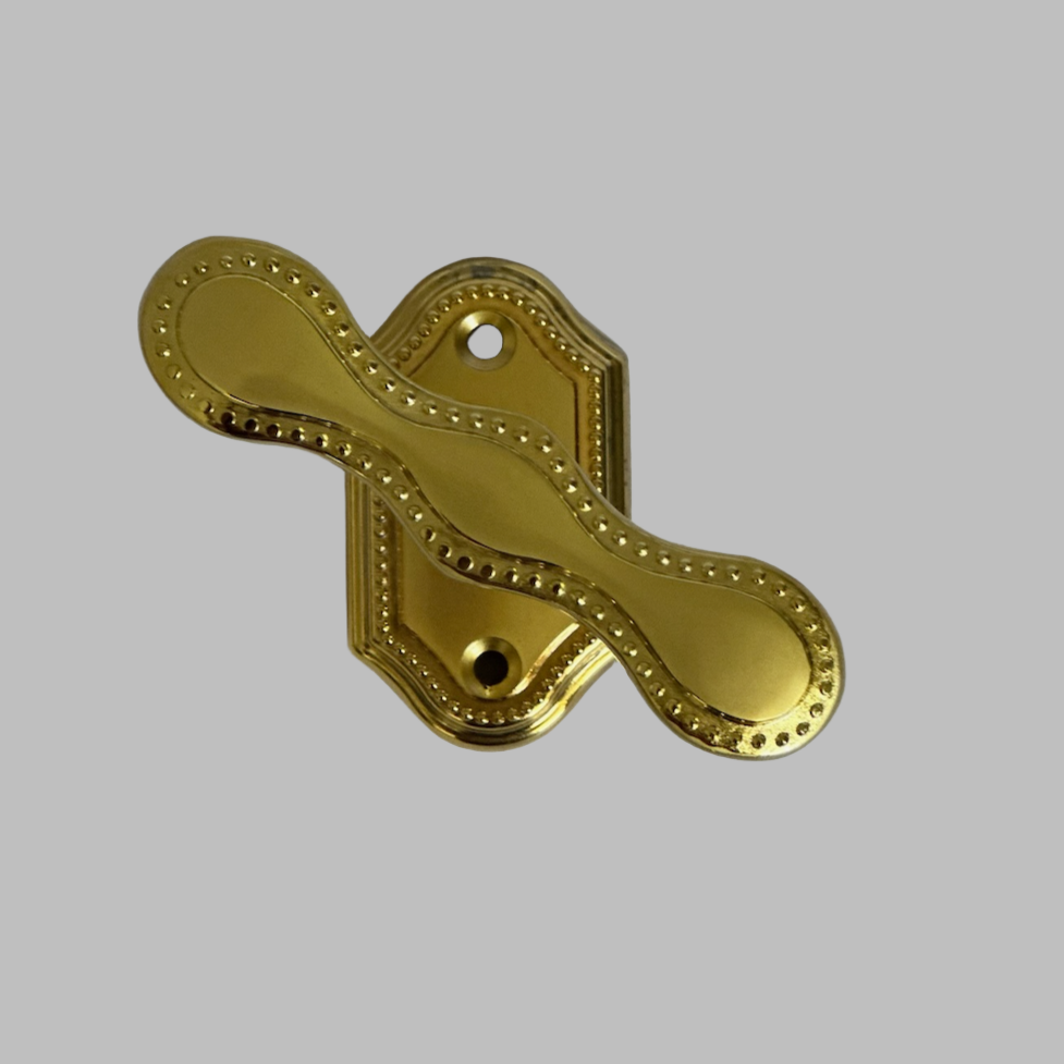 A gold matte window handle against a white background.