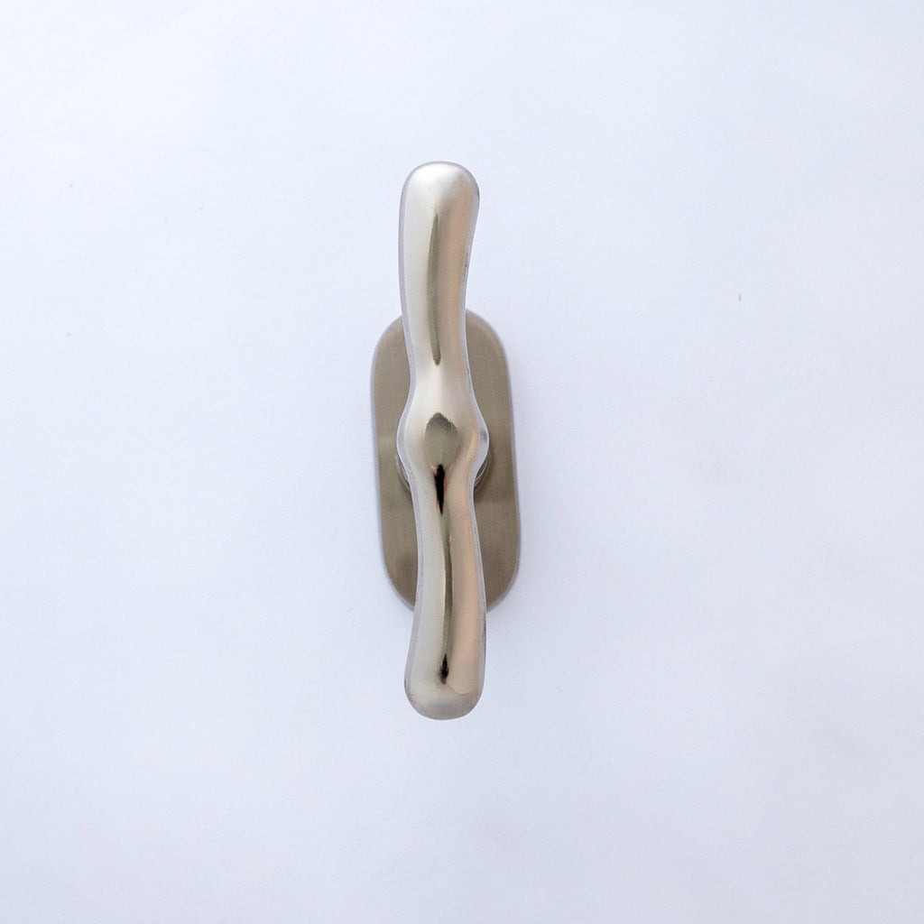 A silver-colored aluminum window handle against a white background.