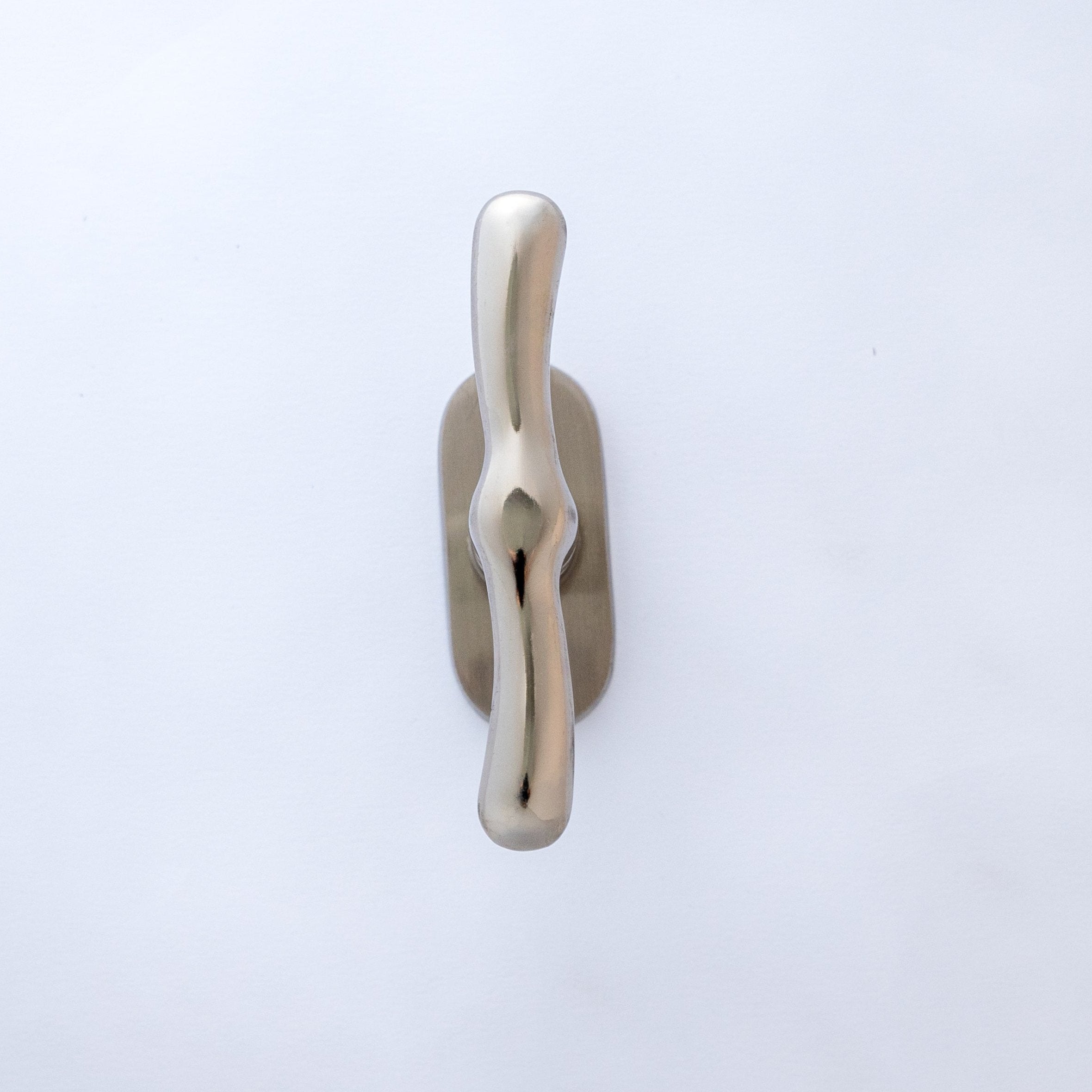 A silver-colored aluminum window handle against a white background.