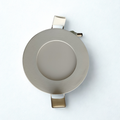 Round metallic object on a white background