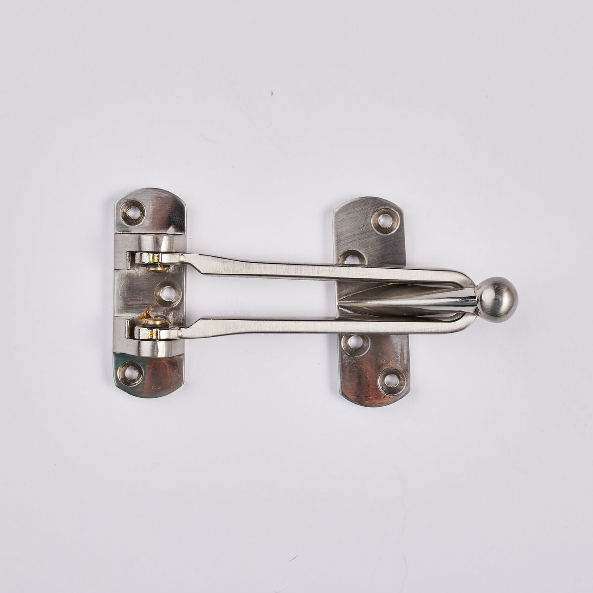 A silver matte door latch made of zinc alloy with a ball on the back, mounted on a door.