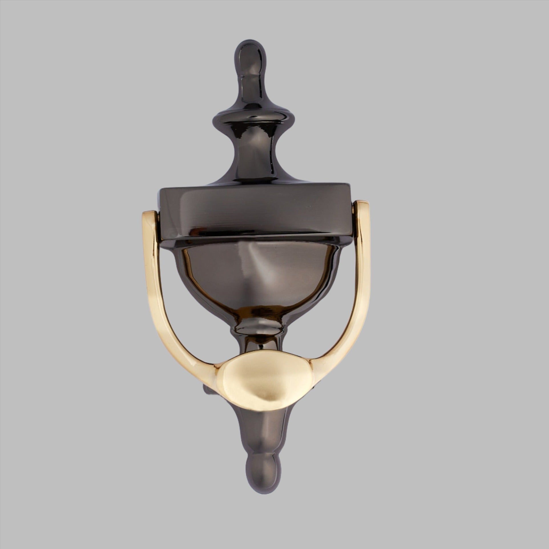 A black and gold door knocker with a polished finish.