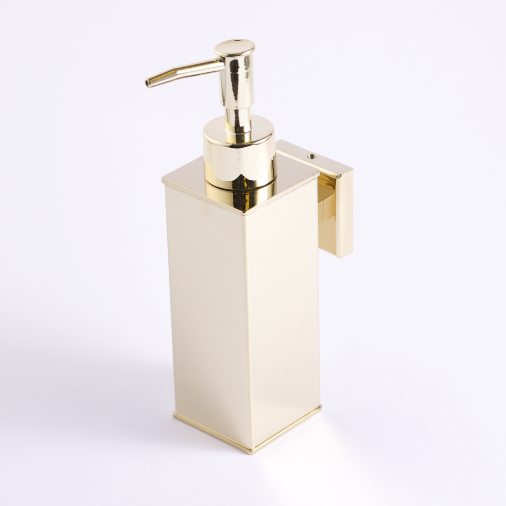 A gold stainless steel soap dispenser with a pump.