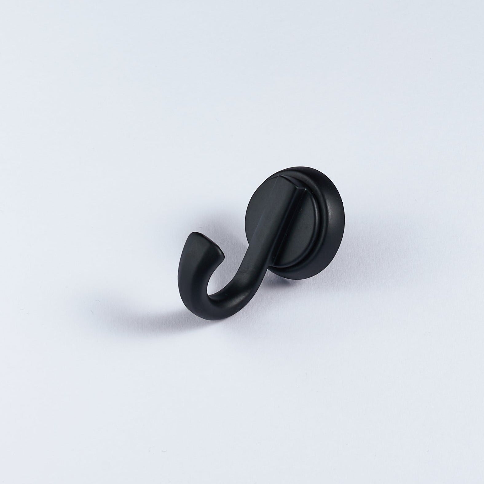 A single black metal hook with a curved shape on a white background.