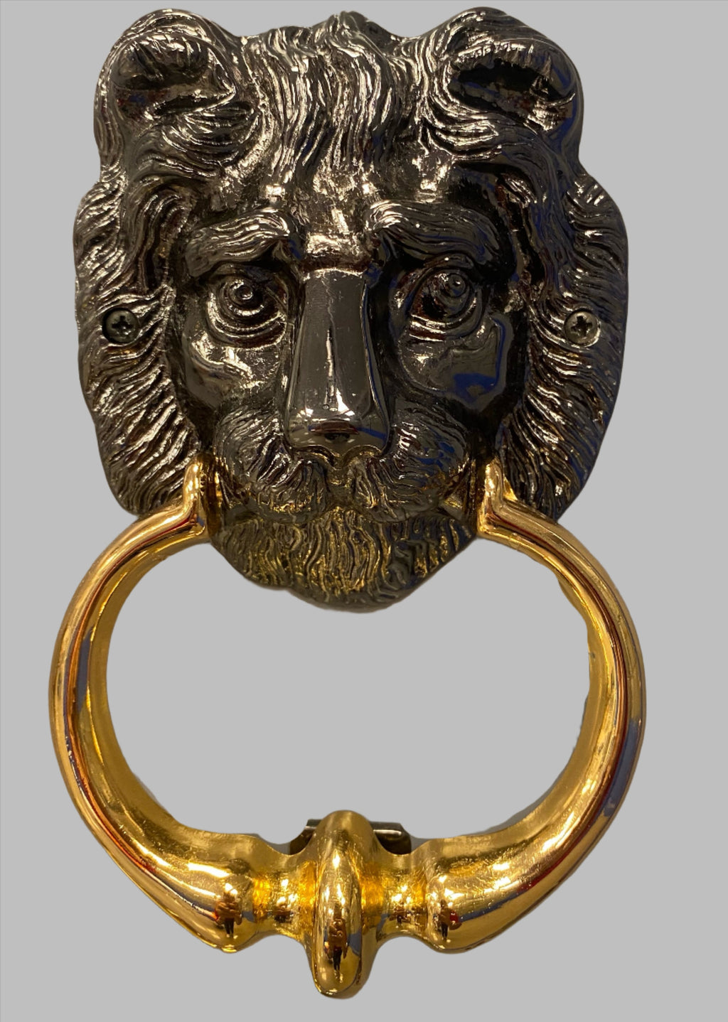 A black door knocker shaped like a lion's head with a gold-colored ring attached to it.
