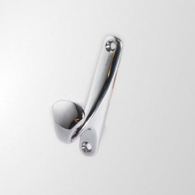 A single silver metal hook mounted on a white wall.